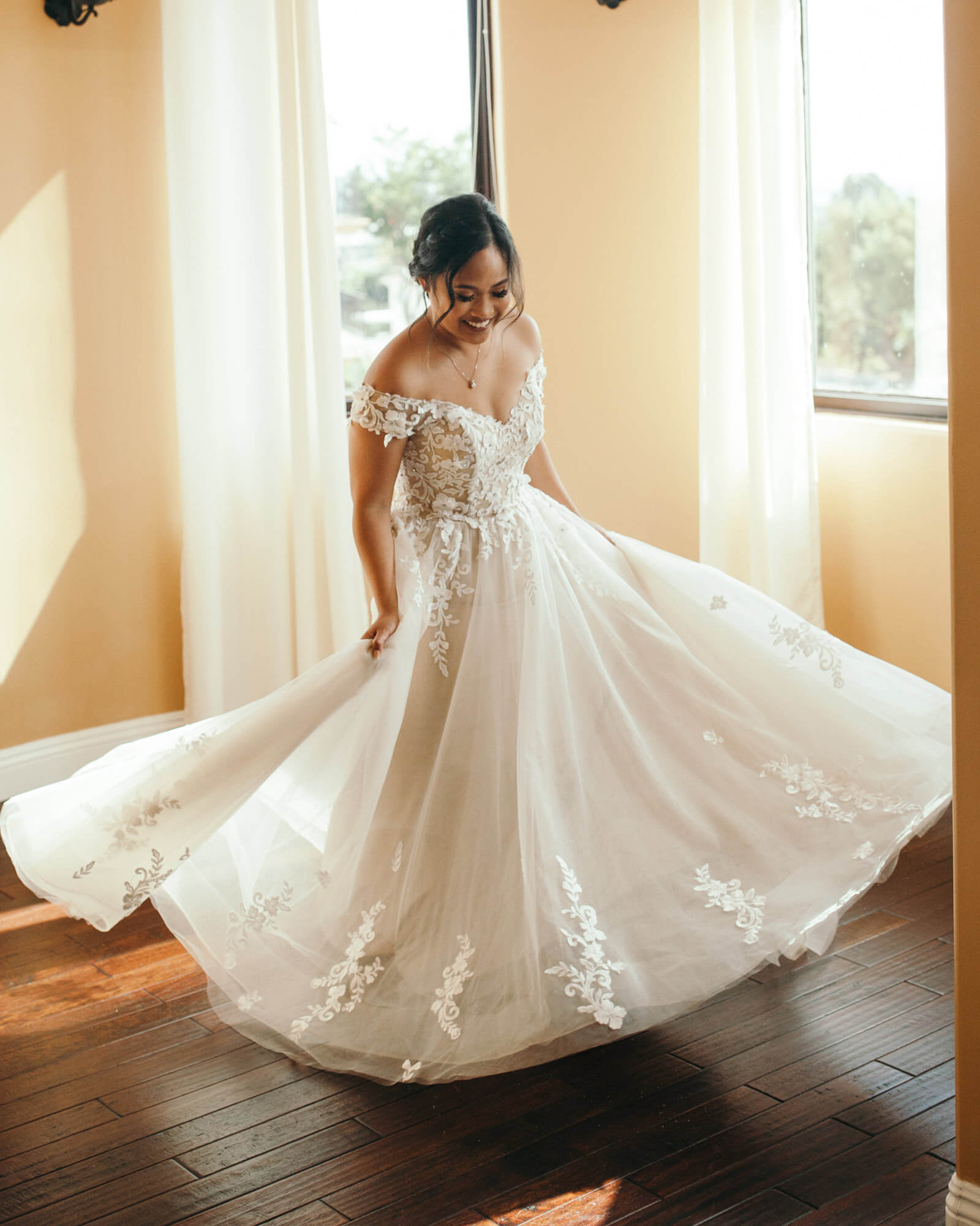 With a twirl-worthy dress this beautiful, we'd be beaming, too!